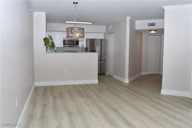 interior space featuring ornamental molding and light hardwood / wood-style floors