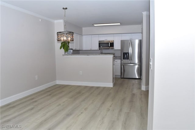 kitchen featuring white cabinetry, light hardwood / wood-style flooring, ornamental molding, appliances with stainless steel finishes, and pendant lighting