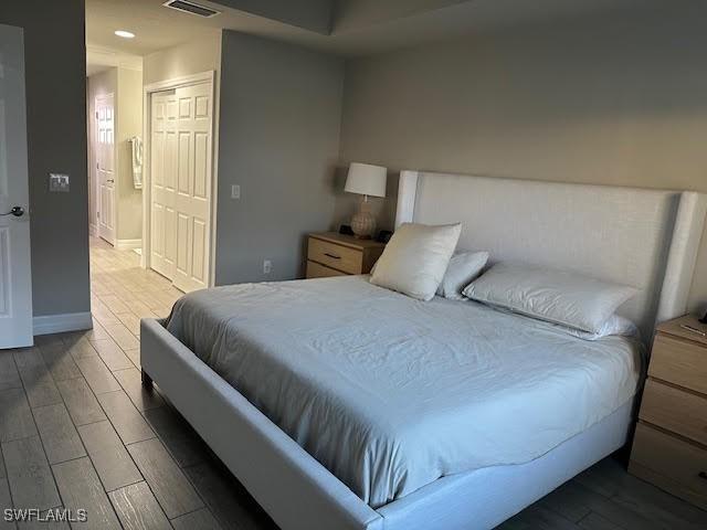 bedroom with a closet and hardwood / wood-style flooring