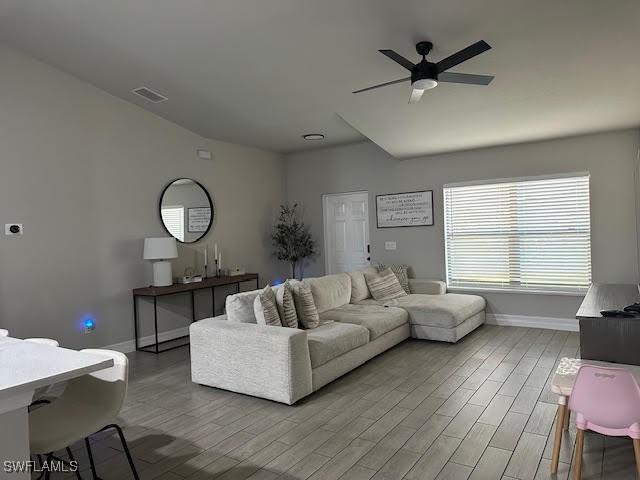 living room featuring hardwood / wood-style flooring and ceiling fan