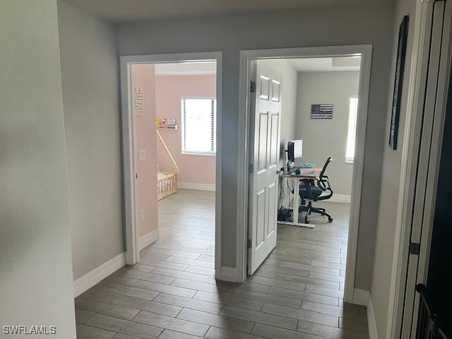 hallway with hardwood / wood-style floors