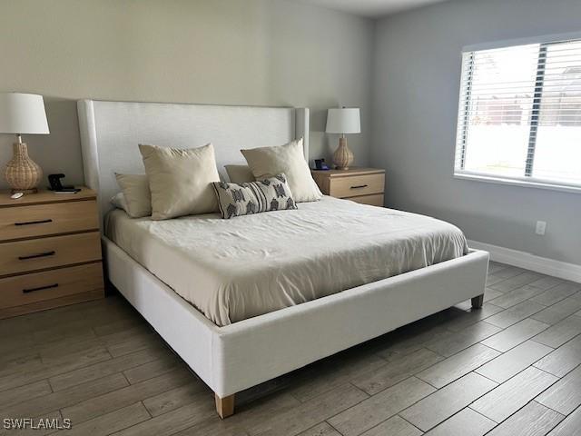 bedroom featuring dark hardwood / wood-style flooring