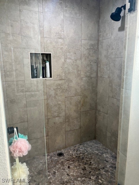 bathroom with tiled shower