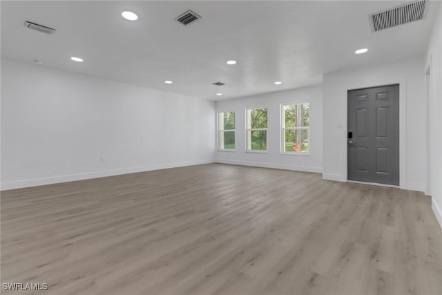 unfurnished living room with light wood-type flooring