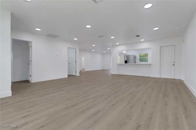 unfurnished living room featuring light wood-type flooring