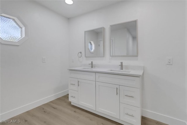 bathroom featuring wood-type flooring and vanity