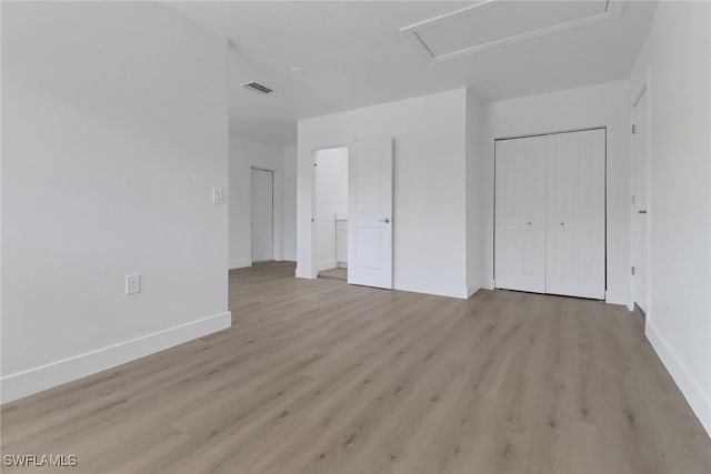 unfurnished bedroom featuring a closet and light hardwood / wood-style flooring