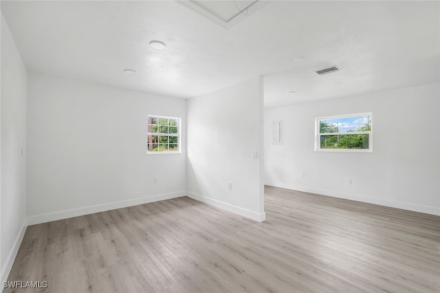 unfurnished room with light hardwood / wood-style flooring and plenty of natural light