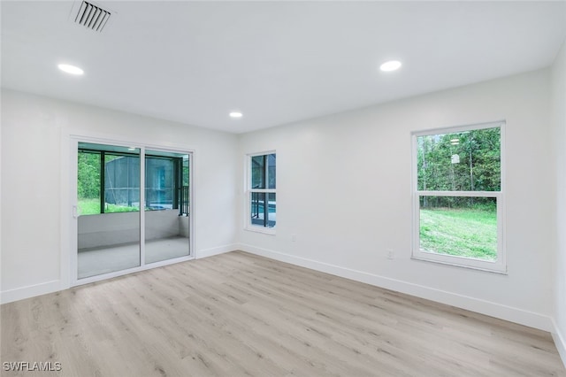 spare room featuring light hardwood / wood-style floors