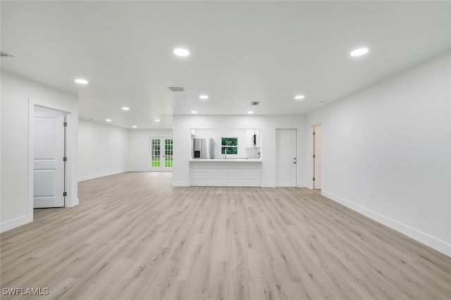 unfurnished living room with light hardwood / wood-style flooring