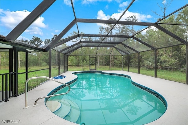 view of pool with a yard, a lanai, and a patio area