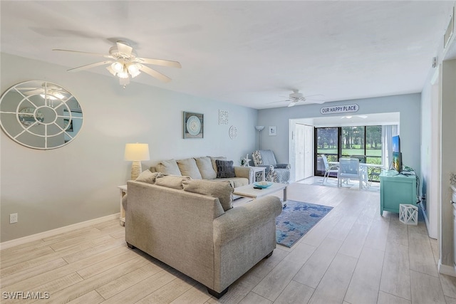 living room with ceiling fan and light hardwood / wood-style floors