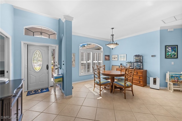 foyer entrance featuring light tile patterned floors and crown molding