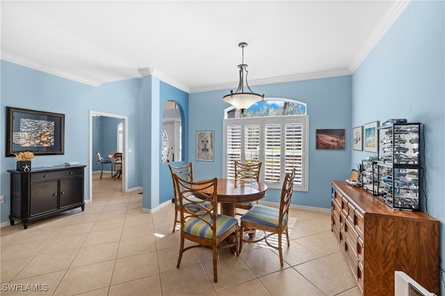 dining area with light tile patterned floors and crown molding