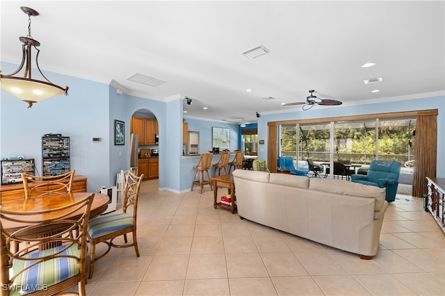 tiled living room featuring ceiling fan and crown molding