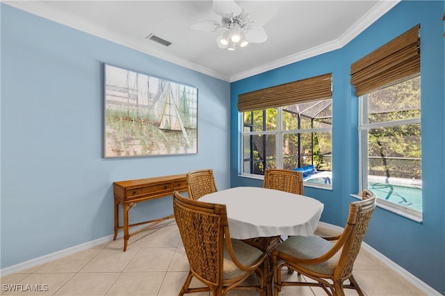 dining room with light tile patterned floors, ceiling fan, and crown molding