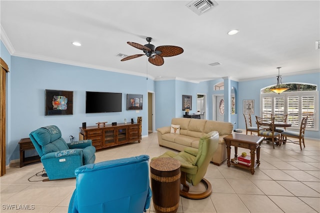 living room with ornate columns, ceiling fan, crown molding, and light tile patterned flooring