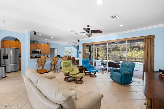 tiled living room featuring crown molding and ceiling fan