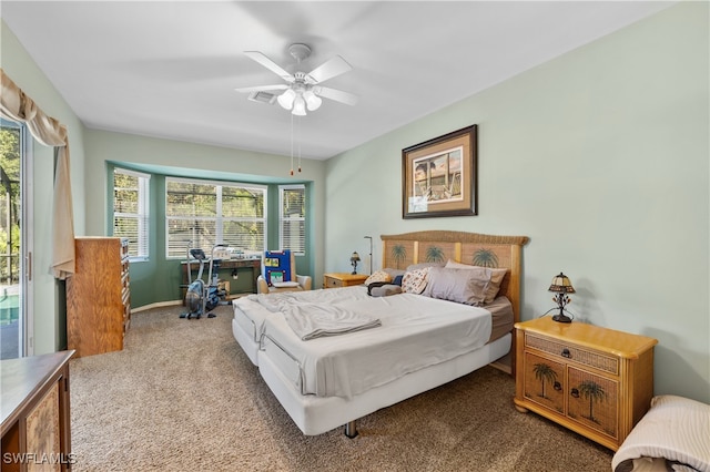 carpeted bedroom with multiple windows and ceiling fan