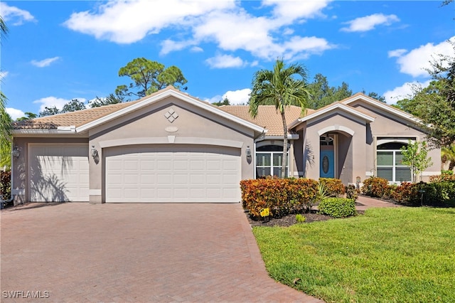 single story home with a front yard and a garage