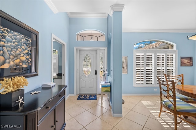 tiled foyer entrance featuring crown molding