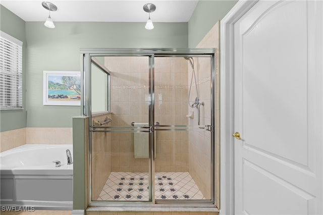 bathroom featuring separate shower and tub