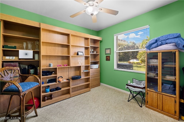 sitting room featuring ceiling fan and light carpet