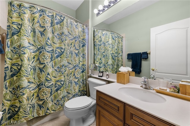 bathroom with tile patterned flooring, vanity, and toilet