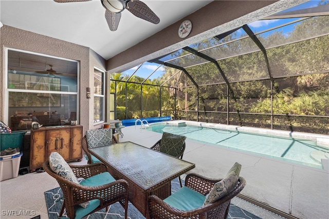 view of pool with ceiling fan, a patio, and glass enclosure