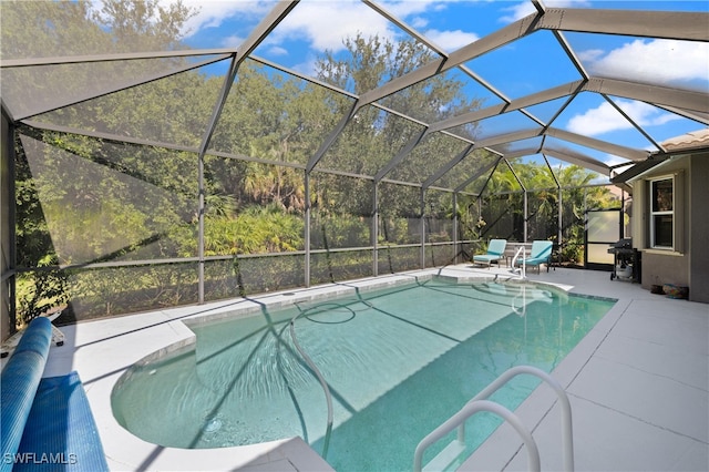 view of pool featuring glass enclosure and a patio