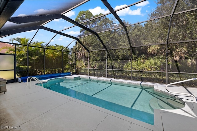 view of swimming pool with a patio and a lanai