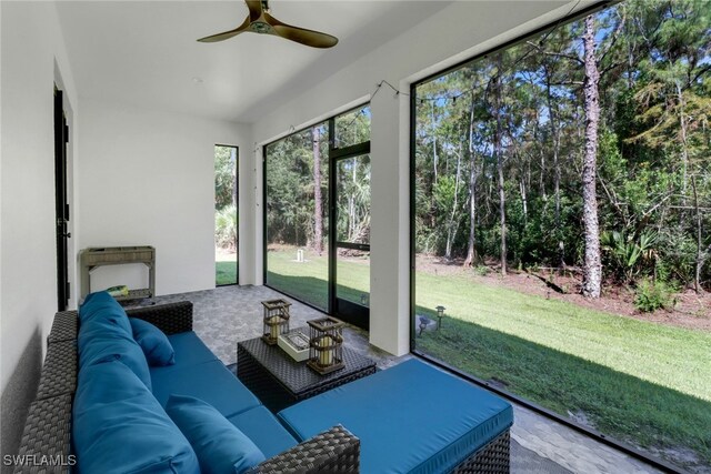 sunroom featuring ceiling fan