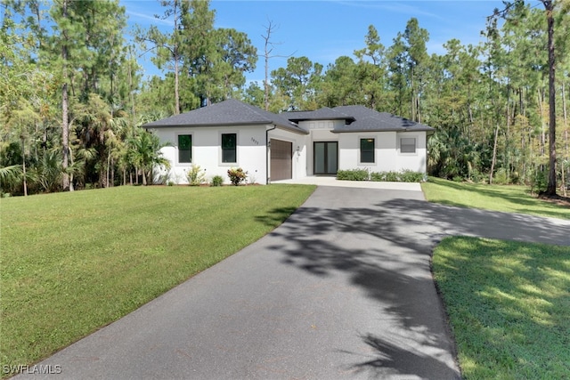 prairie-style house with a garage and a front lawn