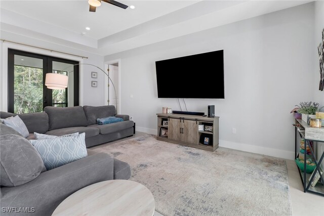 carpeted living room with ceiling fan and french doors