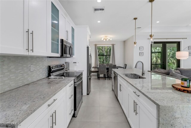 kitchen with appliances with stainless steel finishes, sink, and white cabinetry