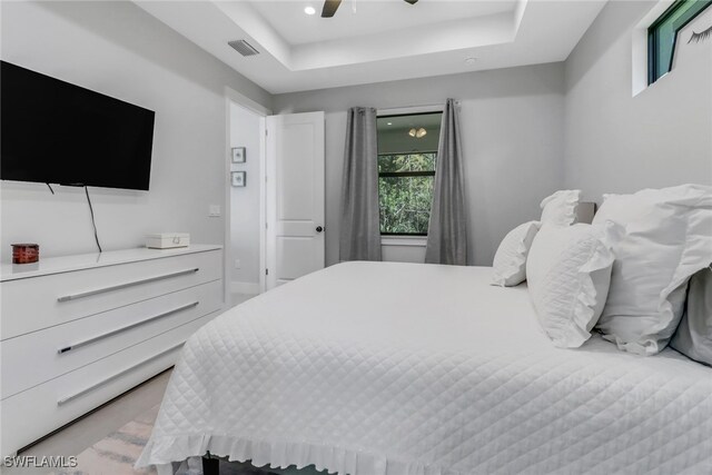 bedroom featuring ceiling fan and a raised ceiling