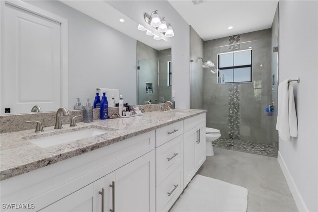 bathroom featuring vanity, toilet, and an enclosed shower