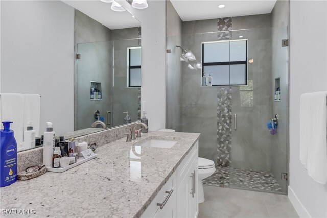 bathroom featuring walk in shower, vanity, and toilet