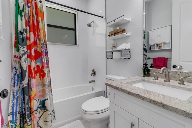 full bathroom with shower / bath combo, vanity, and toilet