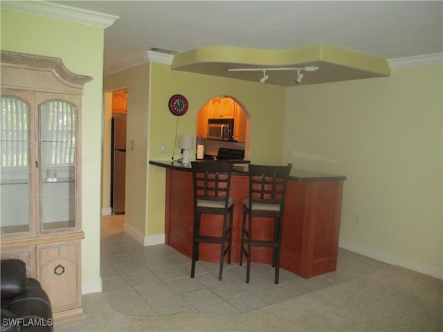 bar with ornamental molding, light colored carpet, and appliances with stainless steel finishes