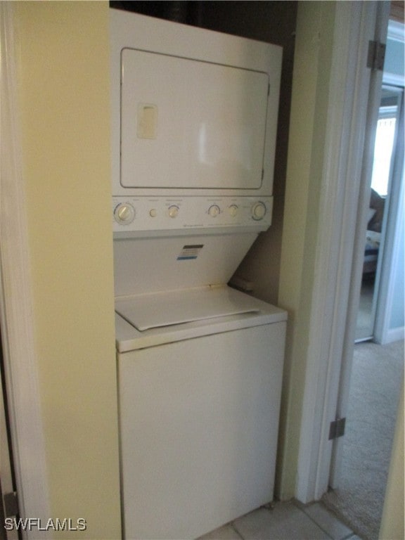 laundry room with stacked washer and clothes dryer