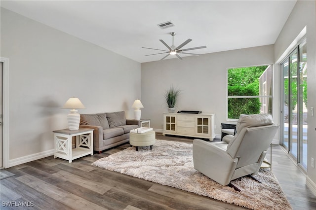 living room featuring ceiling fan and hardwood / wood-style floors