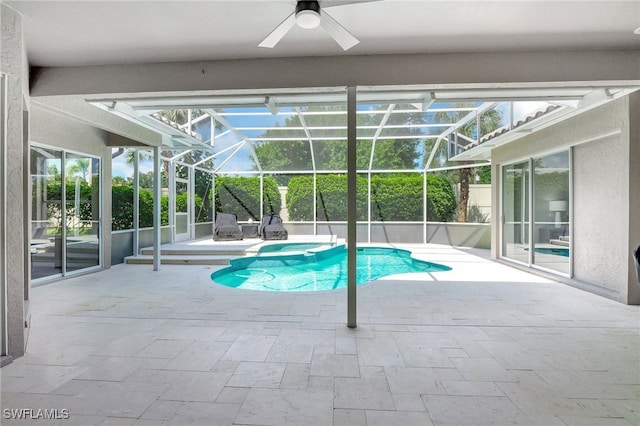 view of pool featuring glass enclosure, ceiling fan, and a patio area