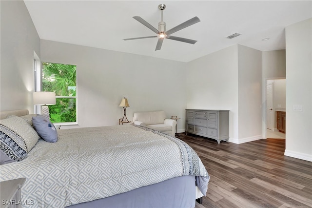 bedroom with dark hardwood / wood-style flooring and ceiling fan