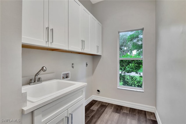 washroom with washer hookup, hookup for an electric dryer, cabinets, light wood-type flooring, and sink