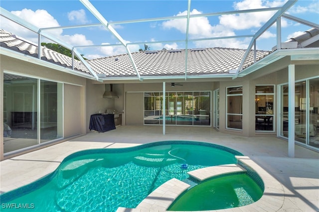 view of pool with glass enclosure, ceiling fan, and a patio