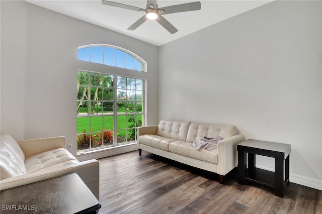 living room featuring ceiling fan and dark hardwood / wood-style flooring