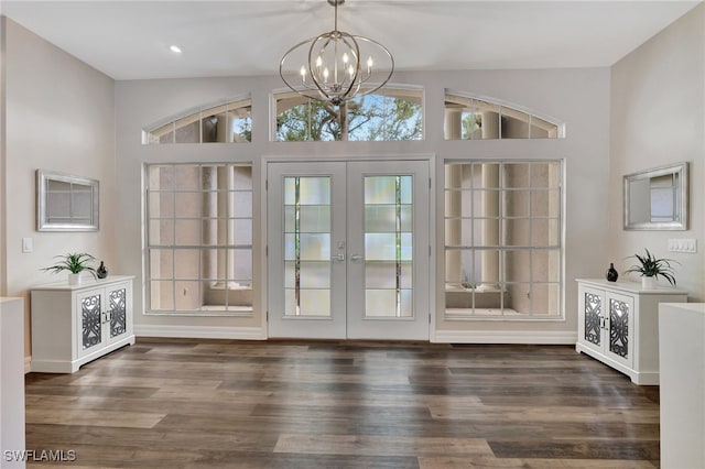 doorway featuring french doors, an inviting chandelier, and dark wood-type flooring