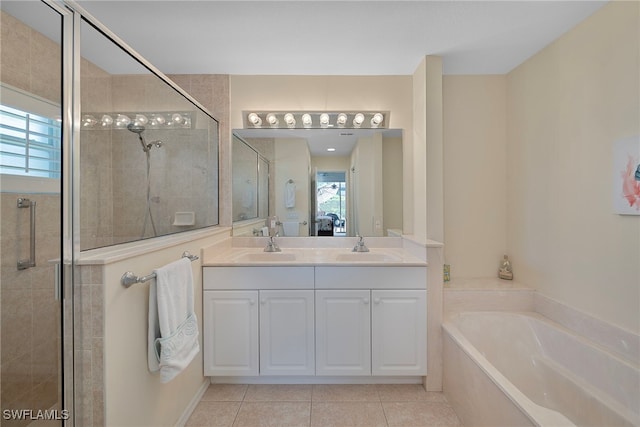 bathroom with a wealth of natural light, shower with separate bathtub, and vanity