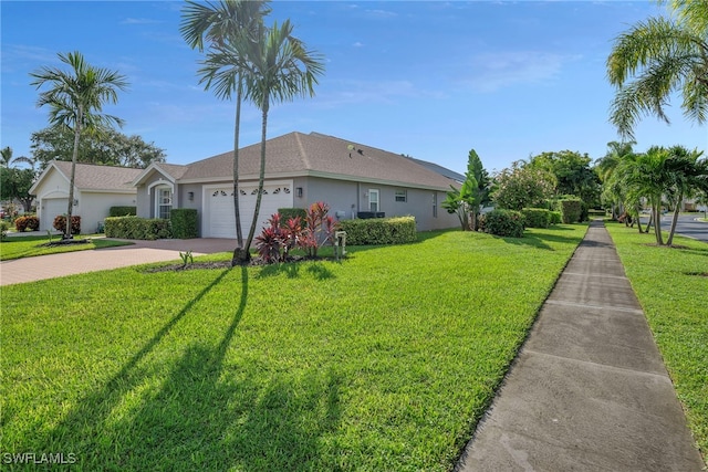 ranch-style home with a garage and a front yard